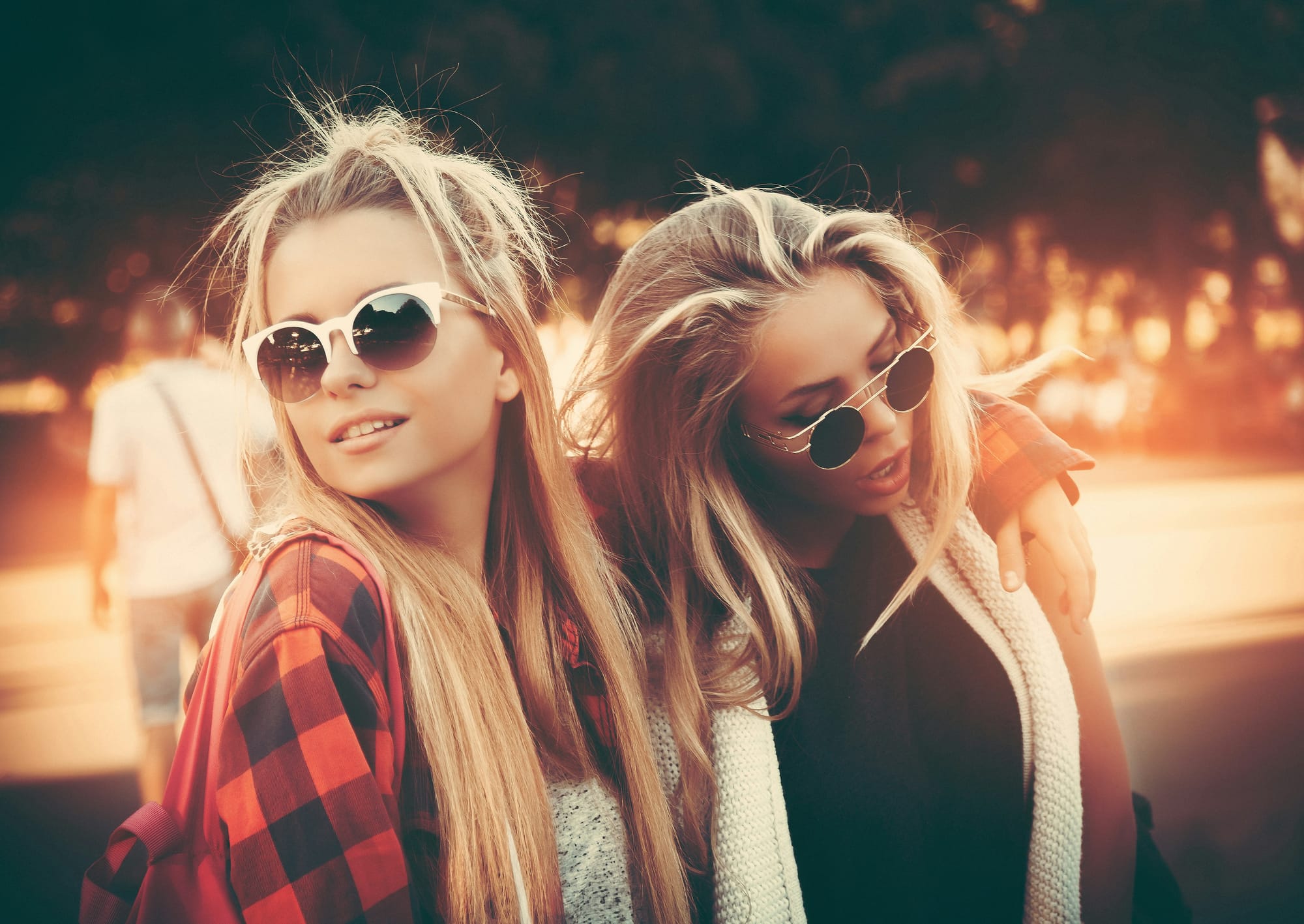 Two girls wearing sunglasses and having fun